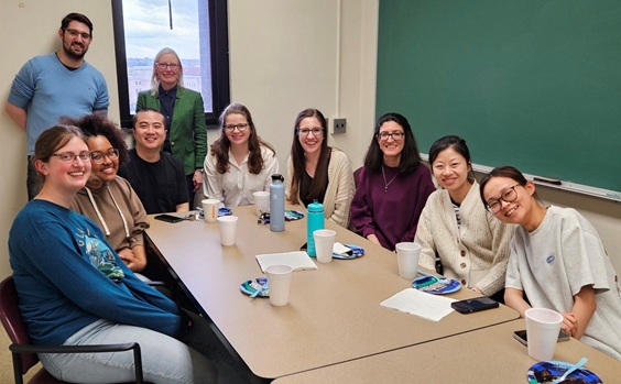 Professor Brummond and students gathered around desks