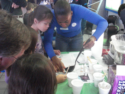 Student works on an experiment with a child