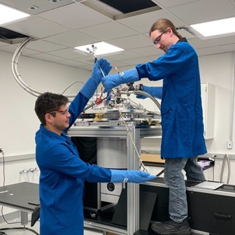 Two students work in a science lab