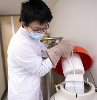Scientist works with liquid nitrogen